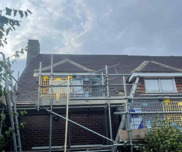 This is a photo of a roof with two dormers that is having some damaged tiles replaced. Works carried out by BN Roofing Letchworth Garden City